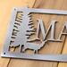 Close up of raw steel on our custom family name metal sign with doe deer silhouette.