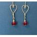 Awaiting Valentine's Day, Argentium silver hearts are on the hook to meet up with cherry red Swarovski beads which dangle below.