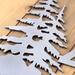 Close up of raw steel on our 3 digit metal house number sign with pine trees.
