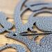 Close up of silver vein powder coat on our metal monogram plaque.