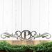 Metal monogram sign with vines, in raw steel.
