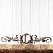Metal monogram sign with vines, in copper vein powder coat.