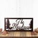 Rectangular family last name metal sign with moose silhouette, in copper vein powder coat.