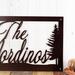 Close up of script lettering on our family last name metal sign, in copper vein powder coat.