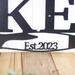 Close up of established year on our propeller metal sign, in silver vein powder coat.