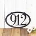 Horizontal oval 3 digit metal house number sign, in silver vein powder coat.