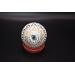 View of bottom of hand painted ornament sitting on little stand.