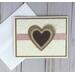 A wedding card with cream embossed cardstock, a tan cardstock mat, a handcrafted burlap heart embellishment and a rose pink ribbon.