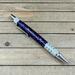 Purple resin and metallic flake click pen