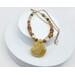 Handcrafted necklace with a yellow opal teardrop pendant, mookaite beads, brass accents, and a gold-toned stainless steel chain