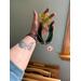 Daffodil suncatcher being held for size reference.