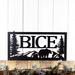 Rectangular metal family name sign with bear and mountains, in matte black powder coat.