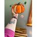 Pumpkin Suncatcher being held for size reference.
