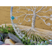 close up wire roots spread out and connected to metal hoop adorned with clear glass crystal facet beads