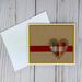 A fall card kit with brown embossed cardstock, yellow cardstock mat, a red ribbon and a plaid fabric and burlap heart embellishment.