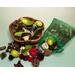 Examples of the handmade, flare-shaped acacia bowl and a sachet displaying a mixed blend of botanicals. Both are approximately 5" - 6" each.