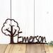 Close up of metal child name plaque with cute tree silhouette, in copper vein powder coat.