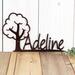 Close up of our boy or girl metal name sign with cute tree silhouette, in copper vein powder coat.