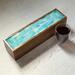 Soft pastel shades of blue swirl together with white on the top of this mango wood tea box that holds 50 tea bags.  It is finished with a glossy resin and is a great gift for any tea lover or someone who loves to entertain.  May tea time extra special with this one of a kind tea caddy.