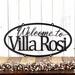 Hanging oval Welcome house name metal sign, in matte black powder coat.