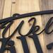 Close up of matte black powder coat on our Welcome to home name metal sign.