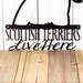 Close up of Scottish Terriers Live Here wording on our metal wall art, in matte black powder coat.
