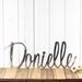 Custom name metal sign with cursive lettering, in raw steel.