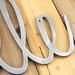 Close up of raw steel on our cursive metal name sign.