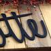 Close up of matte black powder coat on our personalized metal sign.