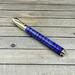 gold and purple pen
