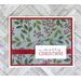 A Christmas card kit with winterberries paper, red cardstock mats, "Merry Christmas" stamped sentiments and red ribbons.