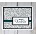 Merry Christmas card making kit with botanical scrapbook paper, black cardstock mat, stamped "Merry Christmas" sentiment and green ribbons.