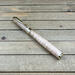 light colored wood and gold hardware rollerball pen