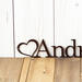 Close up of heart on our child name metal sign, in copper vein powder coat.