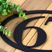 Close up of matte black powder coat on our oval metal house number sign.