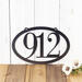 Horizontal oval 3 digit metal house number sign, in silver vein powder coat.