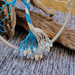 glass teardrop clear beads attached to lbue and white wire roots