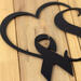 Close up of matte black powder coat on our breast cancer survivor metal sign.