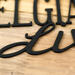 Close up of matte black powder coat on our Belgian Shepherds Live Here metal sign.