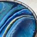 Shades of teal and blue are highlighted by metallic gold paint that reflects the light on this small lazy Susan perfect for a small dining room table or counter. Adds so much pizazz to home decor.