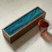 Warm glue and green design on 5-compartment tea box.