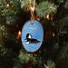A wood slice ornament with a hand-painted hooded merganser on water offered at Cove Creek Photography.