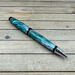 Green and silver cigar pen in chrome hardware