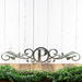 Metal monogram sign with vines, in raw steel.
