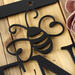 Close up of matte black powder coat on the garden hanging sign.