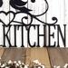 Close up of kitchen word on our custom metal sign, in matte black powder coat.