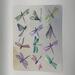 Watercolor dragonfly collage wall art adorned with shimmery iridescent paint to add depth and detail to the wings