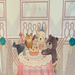 Whimsical birthday design featuring watercolor animals around table with birthday cake and party hats in bowling alley 