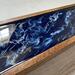 Close up of this tea organizer shows the rich navy blue, white waves and gold accents.  5-compartment wood tea caddy perfect for gift giving.