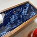 Close up shows the metallic gold glimmering in the glossy resin on this 5-compartment tea caddy.  This tea box is great for the tea lover or a retirement gift.